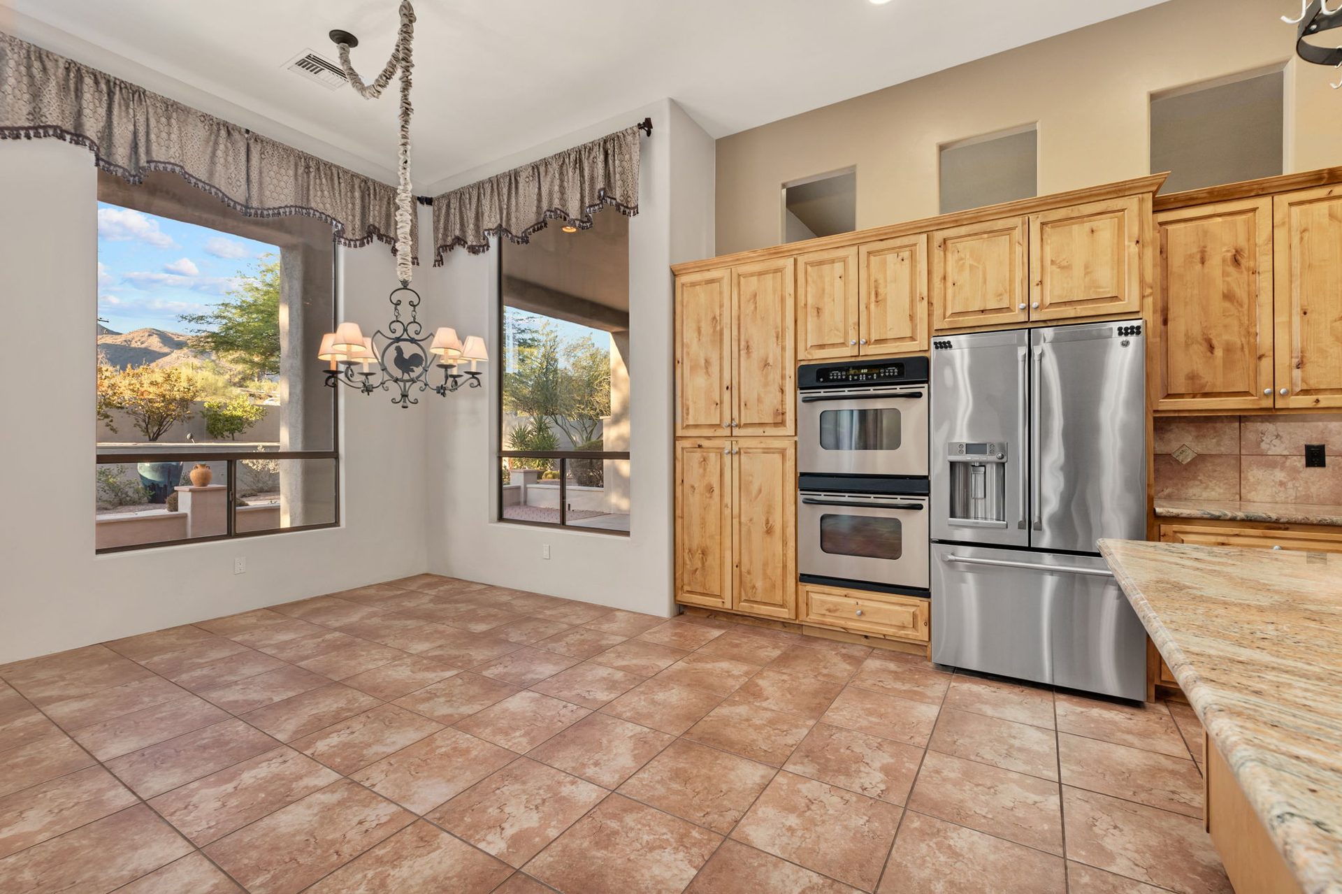 Chef's kitchen with double ovens and granite